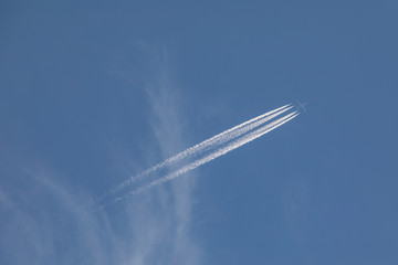 Plane at cruising altitude against blue sky
