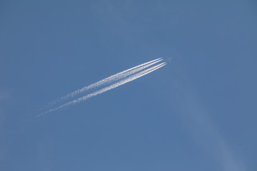 Plane at cruising altitude against blue sky