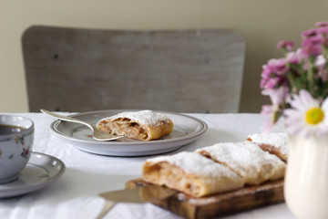 Strudel with apple-pear filling, served with tea. Traditional Austrian dessert.