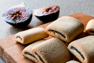 Fig Cookies with fruits on wooden surface.