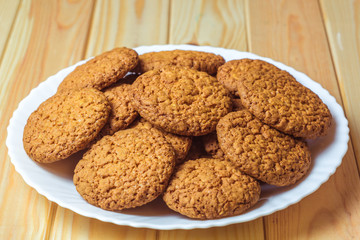 Oatmeal cookies on a white plate.