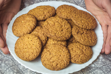 Oatmeal cookies on a white plate.
