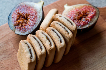 Fig Cookies with fruits on wooden surface.