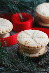 Close-up of mince pies, baked crumbly pastry packed with plump, juicy vine fruits, tangy peel and spices. Concept of Christmas baking.