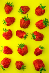 Bright fresh strawberry closeup on yellow background