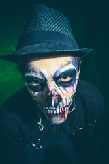 scary halloween skeleton man in jacket and hat studio shot