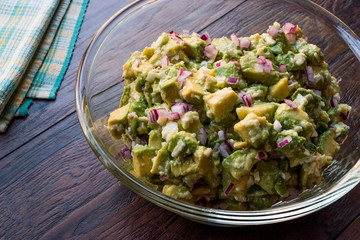 Avocado Salad with Red Onions in glass bowl.