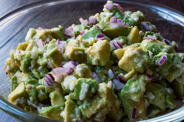 Avocado Salad with Red Onions in glass bowl.