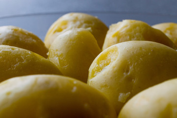 Boiled Potatoes in glass bowl on grey surface.