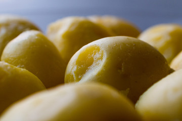 Boiled Potatoes in glass bowl on grey surface.