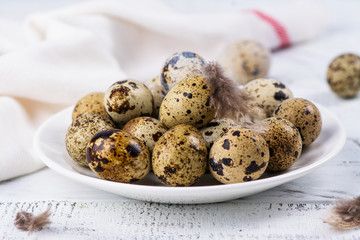 Quail eggs on white plate. Rustic style