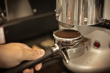 Fototapeta na wymiar Close up barista hands making coffee by machine in coffee cafe.