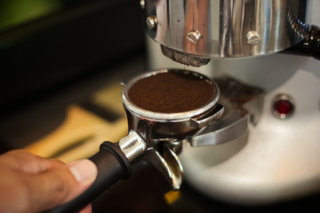 Fototapeta na wymiar Close up barista hands making coffee by machine in coffee cafe.