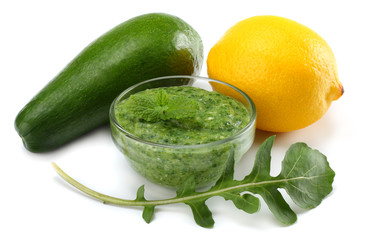 healthy food. avocado with lemon and rucola leaves isolated on white background