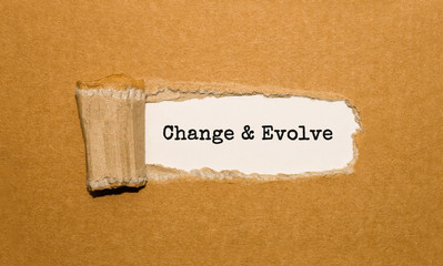 The text Change and Evolve appearing behind torn brown paper