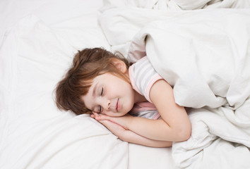 Fototapeta na wymiar Little girl sleeping with his hands under his cheek