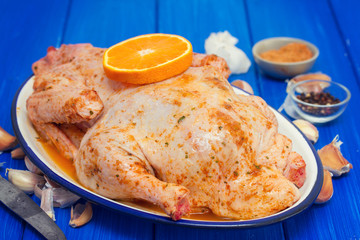 raw duck with spices and orange on white dish