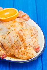 raw duck with spices and orange on white dish