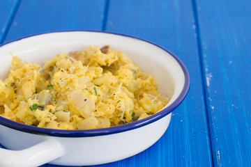 cod fish with egg and herbs on white dish