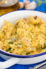 codfish with egg and herbs on white dish