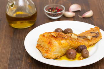 fried cod fish with garlic and olive oil on dish