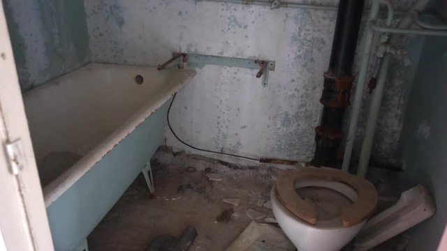 Chernobyl zone, Ukraine - 18th of June 2017: Visit to Pripyat Ghost Town - 4K Destroyed bathroom in one of Pripyat residential houses