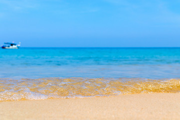 Fototapeta na wymiar Soft Wave Of Blue Ocean On Sandy Beach. Background. Selective focus