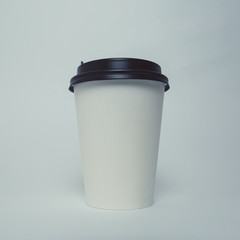 Mockup image of paper cup with cap on clean bacground