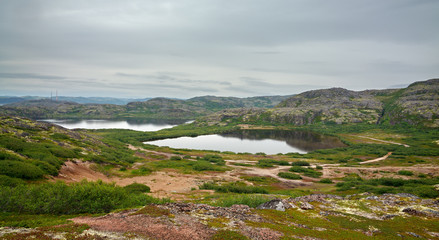 Lake with clean, fresh water on the shore of the Barents sea. Kola Peninsula , Russia.