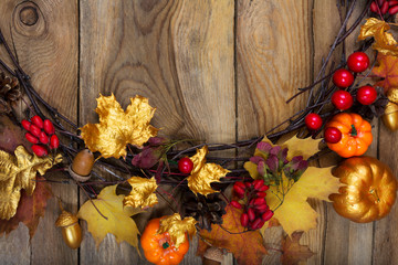 Thanksgiving background with golden pumpkin, acorn and maple leaves wreath, copy space
