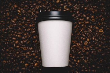 Mockup of coffee beans with white paper cup.
