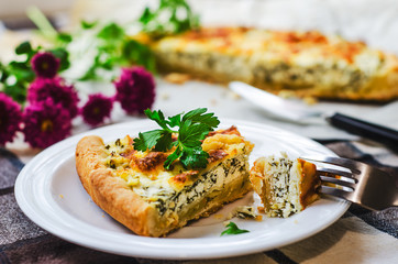 Sliced pie with spinach and cheese. Healthy homemade food photo concept