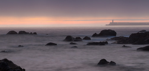 Seascape with a Purple Sunset and Felgueiras Lighthouse in the Background, Oporto, Portugal.