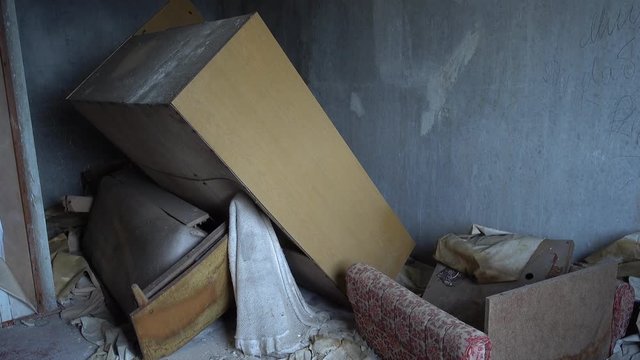 Chernobyl zone, Ukraine - 18th of June 2017: Visit to Pripyat Ghost Town - 4K Living room with broken furniture after pillage in one of Pripyat residential houses