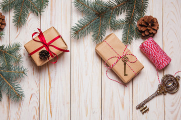 Christmas decorative fir background with craft gifts key red balls on wooden board holiday concept
