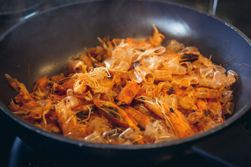 Shrimp shells fried on a pan - one of the steps of preparing shrimp sauce