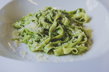 Pasta with spinach sprinkled with parmesan cheese