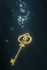 Vintage key under water.