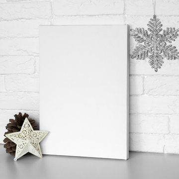 Mock up poster frame in interior. Blank canvas lean at white brick wall. Christmas decoration.