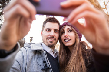 couple taking selfie in the street