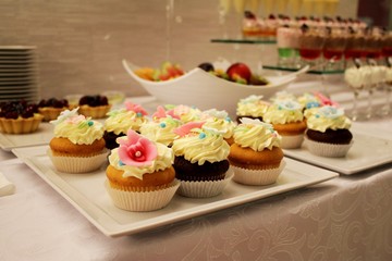 Exhibition of perfect cream cakes, pie decorated with whipped cream and candy flowers