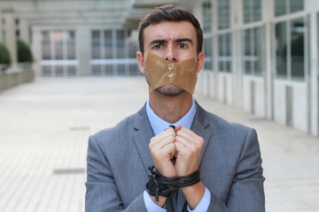 Muted and tied businessman at work 