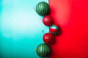 Christmas ball on green and red pepper backround.Christmas greeting card. Merry Christmas. Top view. Copy space. Minimalism concept.