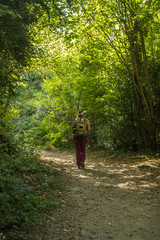 Female athlete to trekking through forests