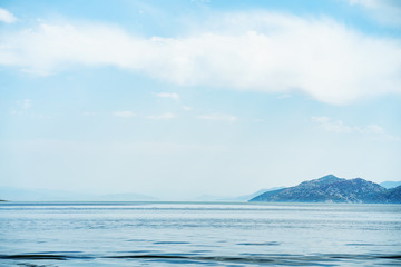 Fototapeta na wymiar Amazing view on tranquil lake water and mountains landscape. Skadar lake, Montenegro