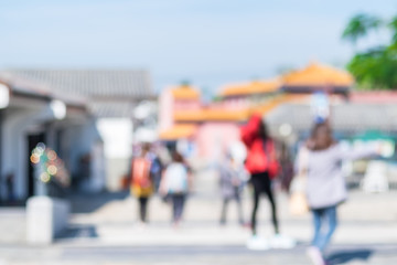 Blurred background of people shopping at market fair in sunny day, blur background with bokeh