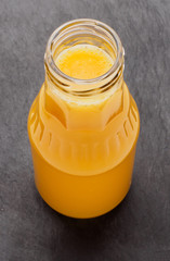 Orange juice bottle, isolated on black background