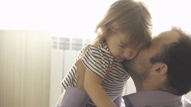 Little Son Rushes Into father Arms At Home. Slow motion. Big Hug. Family values. Kiss.