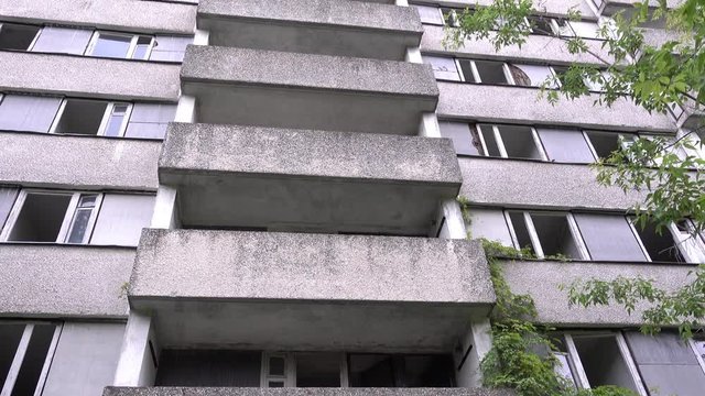 Chernobyl zone, Ukraine - 18th of June 2017: Visit to Pripyat Ghost Town - 4K Tilt up bottom view one of high Pripyat houses, 16 floor building