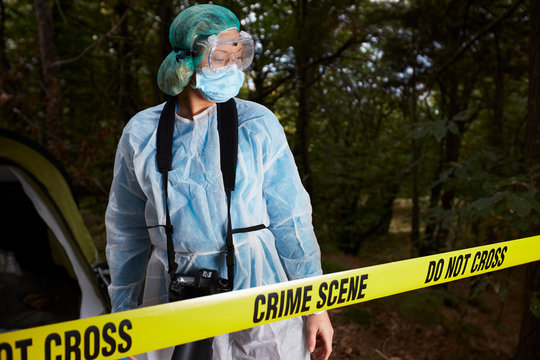 Forensics researcher photographing a blood  at a murder scene